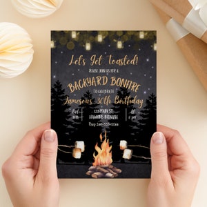 May include: A black and gold invitation for a backyard bonfire to celebrate a 30th birthday. The invitation features a campfire with marshmallows roasting on sticks, a starry night sky, and string lights. The text reads "Let's get toasted! Please join us for a backyard bonfire to celebrate Jameson's 30th birthday. Oct 18th, 123 Main St, Hawkins Indiana, At 8 pm, Rsvp 260-555-5566."