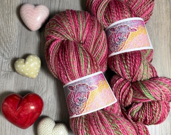 Two skein with up to 852 yards “Love Notes” Handspun Superfine Merino Wool yarn in lovely shades of red, pink and green.