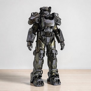 May include: A standing figurine of a suit of power armor with a weathered metallic finish in shades of dark gray, bronze, and silver. The armor features a bulky helmet, articulated shoulder pauldrons, chest plating, and heavy mechanical leg armor.