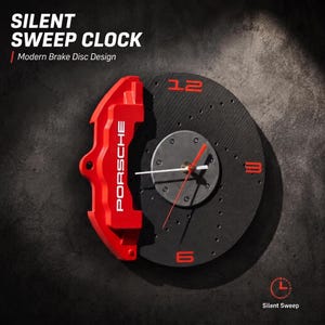 May include: A wall clock designed as a black brake disc with a red brake caliper featuring the text PORSCHE. The clock face includes red numerals 12, 3, 6, and 9, with white and red hands. Text on the image reads SILENT SWEEP CLOCK.