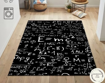 May include: Black and white rug with a pattern of mathematical equations and formulas. The rug has a white background with black text. The text includes equations such as E=mc2, PV=nRT, and F=ma. The rug is made of a soft, durable material and is perfect for adding a touch of science to any room.