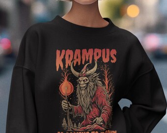 May include: Black sweatshirt with a graphic of Krampus, a horned creature, holding a torch. The text "Krampus is coming to town" is printed below the image.