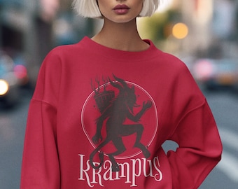 May include: Red sweatshirt with a black and white illustration of Krampus, a mythical creature, holding a basket. The text "Krampus" is printed in white below the illustration.
