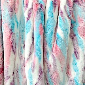 May include: A soft, plush throw blanket with a tie-dye pattern in shades of pink, blue, and purple.