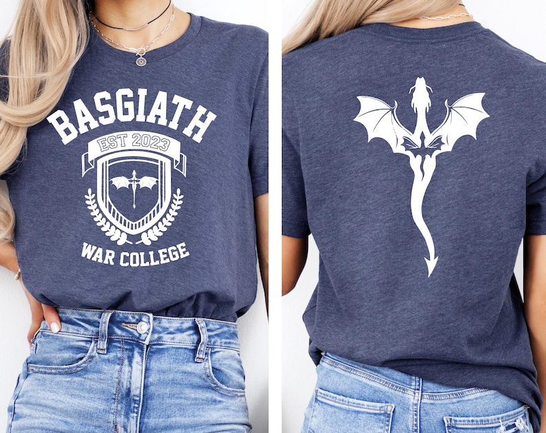 May include: A navy blue t-shirt with a white graphic design on the front. The design features a crest with the text "Basgiath Est 2023 War College". The back of the shirt features a white silhouette of a dragon.
