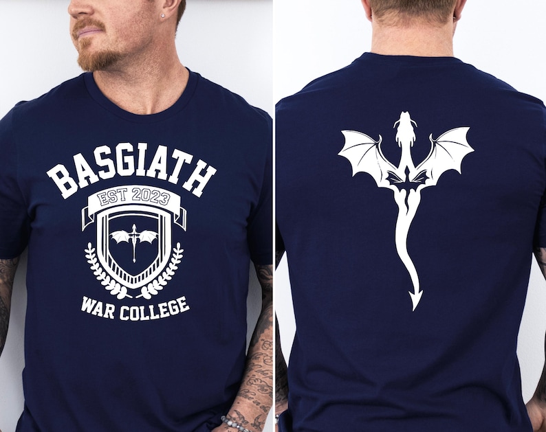 May include: A navy blue t-shirt with a white graphic design on the front. The graphic features a shield with a sword and the text "Basgiath Est 2023 War College". The back of the shirt features a white dragon design.
