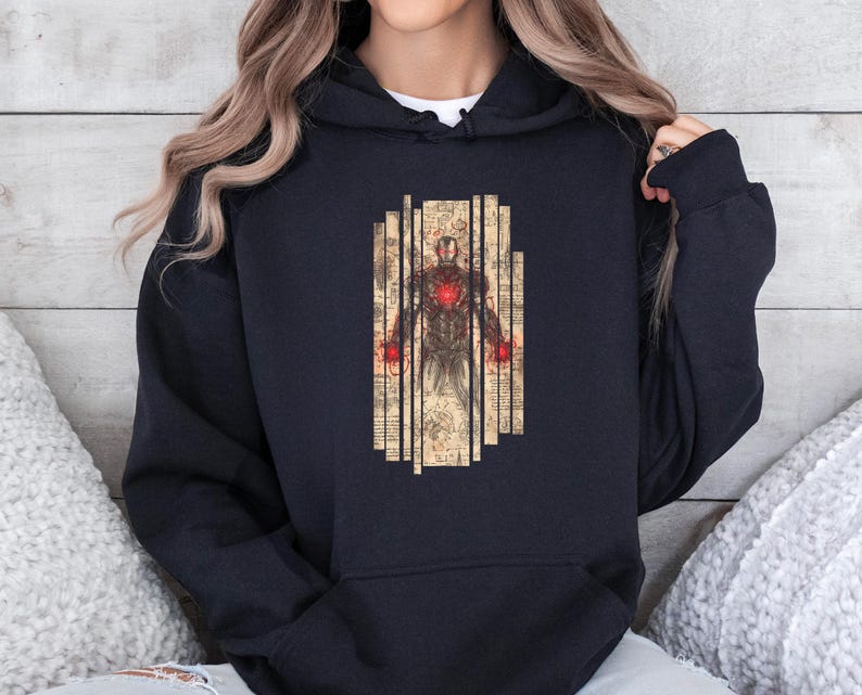 May include: Black hooded sweatshirt featuring a graphic of Iron Man in a vintage style. The design includes a detailed illustration of the character with a red glowing chest and hands, set against a backdrop of vertical lines.