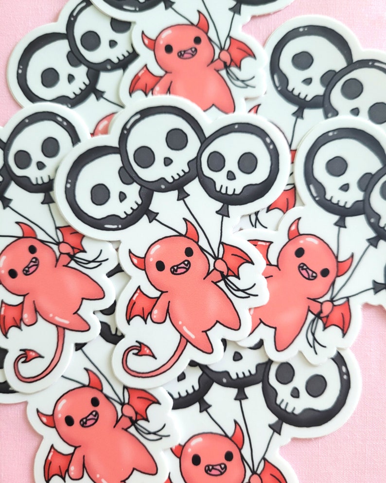 May include: A set of stickers featuring red cartoon devils holding black and white skull balloons. The stickers are on a pink background.