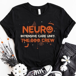 May include: Black t-shirt with orange text that reads "Neuro Intensive Care Unit: The Boo Crew" with a pumpkin and spider web graphic.