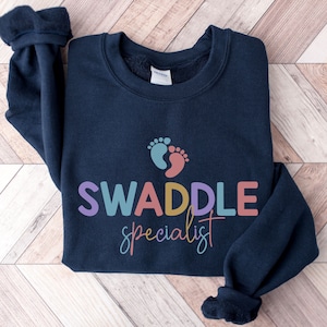 Swaddle Specialist, Labor And Delivery Sweatshirt, NICU Nurse, Mother Baby Unit Sweatshirt, Postpartum Nurse, Nursery Nurse Sweatshirt