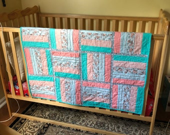 Handmade Quilted Coral and Teal crib sized baby quilt.