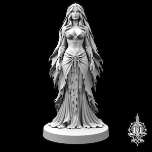 May include: A light gray miniature figurine of a standing figure with long flowing hair, wearing a fitted bodice and a tattered, floor-length gown with a central decorative element at the waist, all mounted on a circular base against a black background.