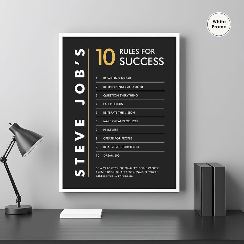 K&ouml;nnte beinhalten: Ein schwarz-wei&szlig;es Motivationsposter mit wei&szlig;em Rahmen. Das Poster zeigt ein Zitat von Steve Jobs mit 10 Regeln f&uuml;r den Erfolg. Der Text ist in goldener Schrift.