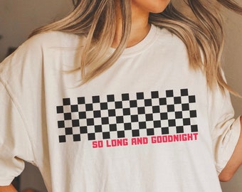 May include: A white oversized t-shirt with a black and white checkered pattern and the text "SO LONG AND GOODNIGHT" in pink.