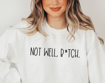 May include: White sweatshirt with the text "NOT WELL, B*TCH." printed in black.