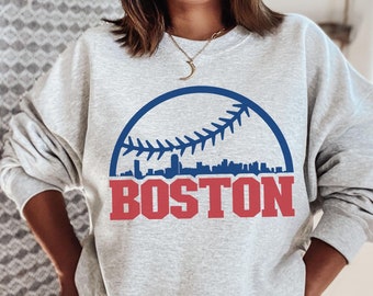 May include: A gray sweatshirt with a blue and white baseball graphic and the word "BOSTON" in red letters.