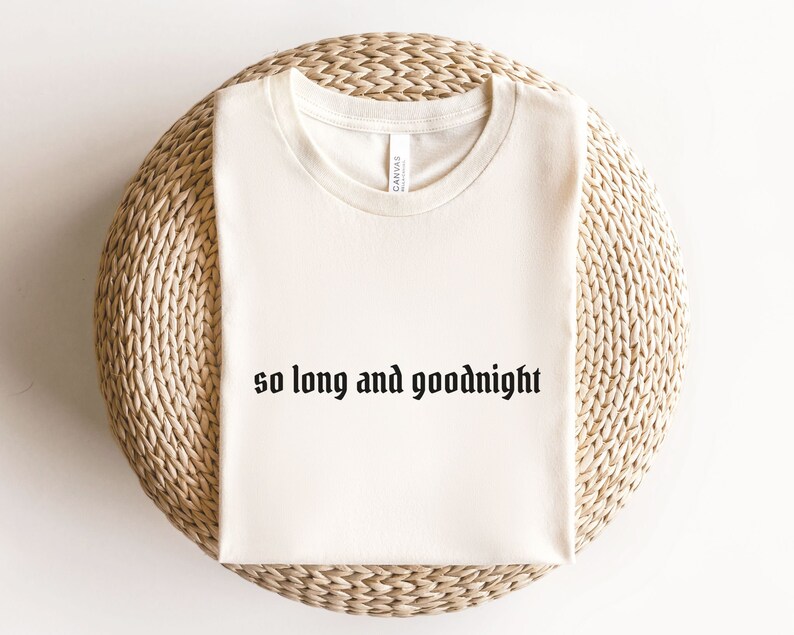 May include: A cream-colored t-shirt with the text "so long and goodnight" printed in black.