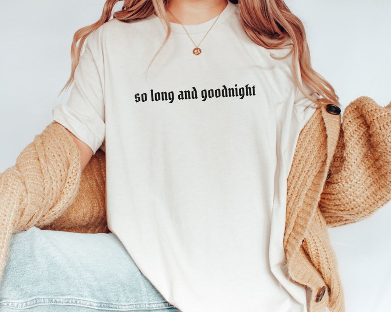 May include: White t-shirt with the text "so long and goodnight" in black gothic font.