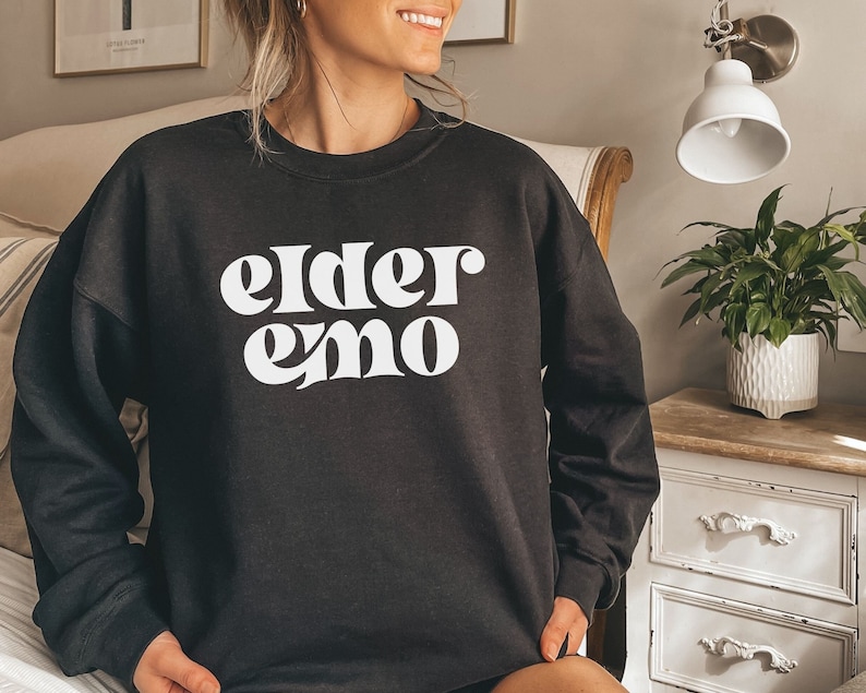 May include: Black sweatshirt with white text that reads "elder emo".