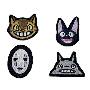 May include: Four embroidered patches featuring cartoon characters. Includes a brown cat with a wide grin, a black cat with a pink mouth, a white-faced character, and a grey creature with a toothy smile.