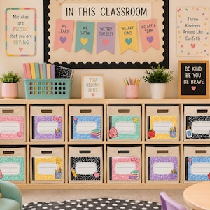 May include: A light wood storage unit with ten beige fabric bins, each featuring a colorful, patterned label with school-themed graphics. The unit is placed in a classroom setting with motivational posters, potted plants, and a teal supply basket.