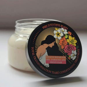 May include: A clear glass jar filled with a creamy white hair treatment. The black lid features the text "PURE INTENTIONS BEAUTY" and "MIRACLE REPAIR FOR DRY, DAMAGED, AND FRIZZY HAIR". The lid also has a floral design and a silhouette of a woman.