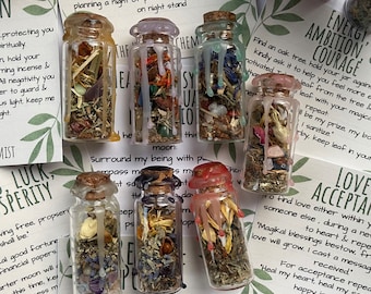 Spell Jars filled with different herbs crystals anointed spell candles made using herbal witchcraft for healing love psychic success protect