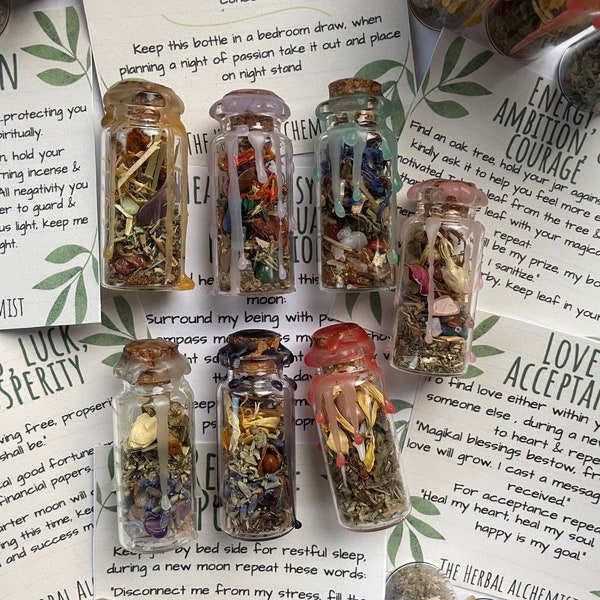 Spell Jars filled with different herbs crystals anointed spell candles made using herbal witchcraft for healing love psychic success protect