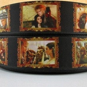 May include: Black ribbon with multiple images of scenes from the movie Labyrinth. The images are framed in gold and feature David Bowie and Jennifer Connelly.