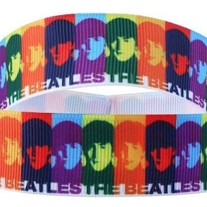 May include: Multicolored ribbon with a repeating pattern of the Beatles' faces and the text "The Beatles" in white.