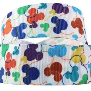 May include: White ribbon with a repeating pattern of colorful Mickey Mouse heads. The ribbon is folded in half, showing the pattern on both sides.