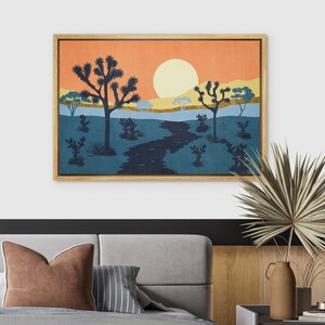 K&ouml;nnte beinhalten: Ein gerahmter Druck eines W&uuml;stenlandschafts mit untergehender Sonne, einem gewundenen Fluss und silhouettierten Joshua-B&auml;umen. Der Druck hat eine Vintage-&Auml;sthetik mit einer warmen Farbpalette aus Orange, Gelb, Blau und Gr&uuml;n.