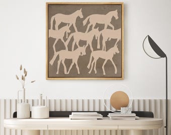 May include: A framed print with a brown background and a layered design of horses in a light beige color. The horses are silhouetted and appear to be running or walking.