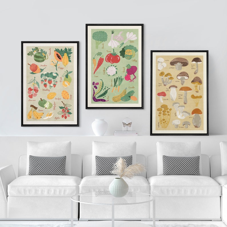 May include: Three framed prints with illustrations of various fruits, vegetables, and mushrooms. The prints are in black frames and have a vintage aesthetic. The prints are hung on a white wall above a white couch with black and white patterned pillows.