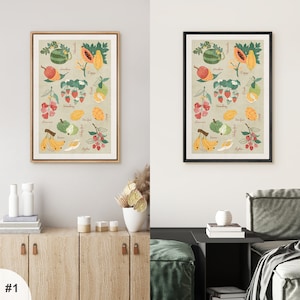 May include: Two framed prints of colorful illustrations of various fruits with their names written below each fruit. The prints are on a light beige background and have black frames.