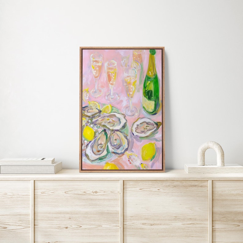 May include: An oil painting of a still life featuring oysters, champagne, and lemons on a pink tablecloth. A green champagne bottle and several champagne flutes are visible. The oysters are arranged on a green plate.
