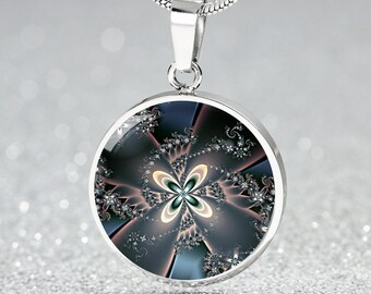 May include: A silver necklace with a round pendant featuring a colourful abstract floral design. The pendant has a silver border and a glass-like surface.
