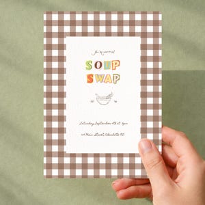 May include: A rectangular invitation card featuring a brown and white gingham border. The center white panel displays the text "You're invited!", "SOUP SWAP", a line drawing of a bowl, "EST '06", "Saturday September 4th at 3pm", and "123 Main Street, Charlotte NC".