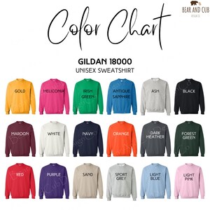 May include: Color chart of Gildan 18000 unisex sweatshirts in various colors, including gold, maroon, and red. The chart displays the available colors with their names, such as "Irish Green" and "Light Pink". The text "Color Chart" is at the top.