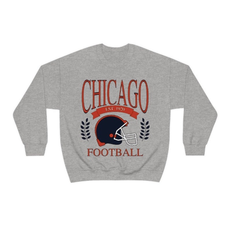 May include: A gray sweatshirt with a vintage-style graphic of a football helmet and the text "CHICAGO EST. 1920 FOOTBALL".