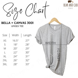 May include: A light gray Bella + Canvas 3001 unisex tee shirt displayed on a hanger. The image includes a size chart with measurements in inches for sizes XS to 3XL. The chart shows the width and length of the shirt for each size.