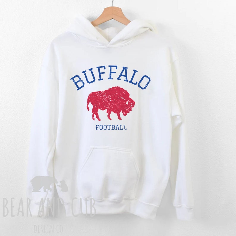 May include: White hoodie with a red and blue buffalo silhouette and the text "BUFFALO FOOTBALL" printed on the front.