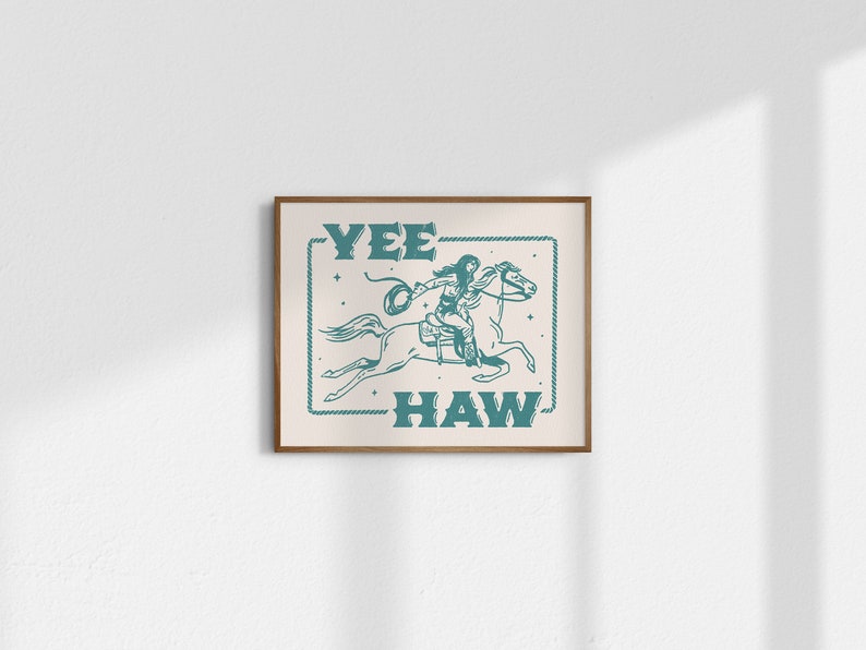 May include: A teal blue and white print with a cowgirl riding a horse. The text "Yee Haw" is written in a vintage style font.