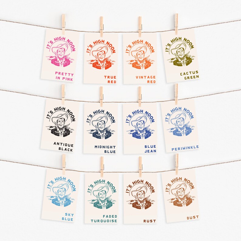 May include: Ten different colour variations of a vintage "It's High Noon" graphic featuring a cowboy with a gun. The colours include: Pretty in Pink, True Red, Vintage Red, Cactus Green, Antique Black, Midnight Blue, Blue Jean, Periwinkle, Sky Blue, Faded Turquoise, Rust, and Dust.