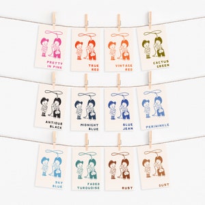 May include: Twelve illustrated cards featuring cowboys with different coloured backgrounds. The colours are: Pretty in Pink, True Red, Vintage Red, Cactus Green, Antique Black, Midnight Blue, Blue Jean, Periwinkle, Sky Blue, Faded Turquoise, Rust, and Dust.