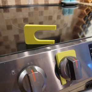 Grilles de sécurité pour boutons de cuisinières électriques/à gaz