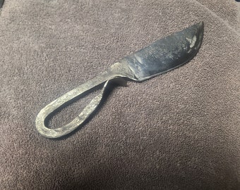 May include: A hand-forged knife with a unique, twisted handle. The blade is made of metal and has a slightly curved shape.