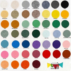 May include: A color chart featuring a variety of felt circles in a wide spectrum of colors. Colors include white, black, gray, blue, green, yellow, pink, orange, red, and brown. Each circle is labeled with its corresponding color name.