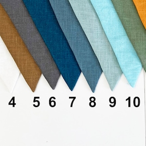May include: Thirteen fabric swatches in various colors and textures, including beige, white, brown, gray, blue, teal, light blue, green, orange, and pink.