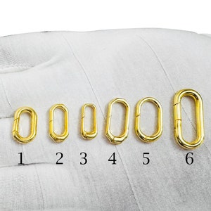 May include: Six gold-toned metal lobster clasps of varying sizes, numbered 1 through 6.